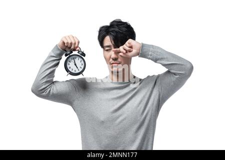 Der junge Mann mit dem Wecker Stockfoto