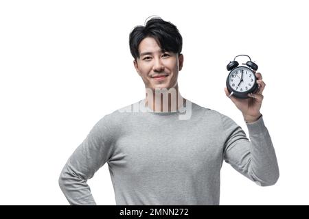 Der junge Mann mit dem Wecker Stockfoto