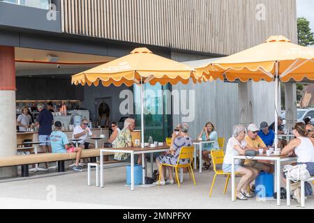 Mona Vale Surf Club Gebäude und angrenzendes Cafe mit Rentnern und älteren Leuten, die Getränke und Essen genießen, Sydney, NSW, Australien Stockfoto