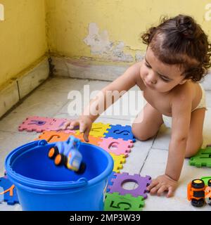 Süßer kleiner Junge Shivaay Sapra auf dem Balkon zu Hause im Sommer, süßer kleiner Junge Fotoshooting bei Tageslicht, kleiner Junge genießt zu Hause während Pho Stockfoto