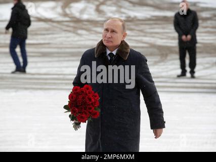 Russian President Vladimir Putin walks to put flowers on a monument at Nevsky Pyatachok near Kirovsk, to mark the 75th anniversary of the battle that broke the Siege of Leningrad, in St, Petersburg, Russia, Thursday, Jan. 18, 2018. As many as 200,000 Soviet soldiers were killed between September 1941 and May 1943 in fighting to break the Nazi siege of Nevsky Pyatachok, an area about 50 kilometers (30 miles) southeast of St. Petersburg which was then called Leningrad. (AP Photo/Dmitri Lovetsky, pool)
