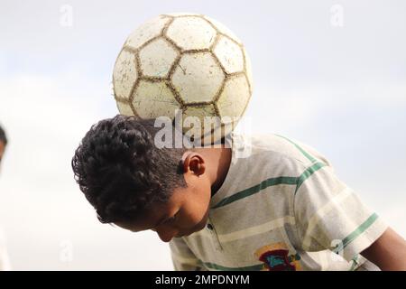 Karatschi Pakistan 2019, ein Kind, das am Sonntagmorgen mit seinem blauen Fußball für ein Foto posiert, asiatische Kinder, lokale Sportarten, Fußball in Pa Stockfoto