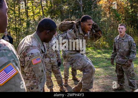 Mit seinem St. Cadet Christopher Lancaster, die Teamkollegen der Universität von Augustine, jubeln ihn an und drängt sich durch die letzten Sekunden des Functional Fitness Events bei der 4. Brigade's Army ROTC Ranger Challenge am 15. Oktober in Fort A.P. Hügel. In diesem zeitlich begrenzten Staffelrennen hatte jedes Teammitglied eine Reihe von drei anstrengenden Übungen absolviert. Bei der letzten Übung machten Cadets viele 35-Pfund Schulterboxen, so gut sie konnten in einer Minute. Am zweiten Wettbewerbstag traten die Teams an zehn verschiedenen Veranstaltungen an, bevor sie ihren Tag mit einem 6-km-Rucksack beendeten. Die beiden besten Teams repräsentieren 4. Brigaden in t Stockfoto