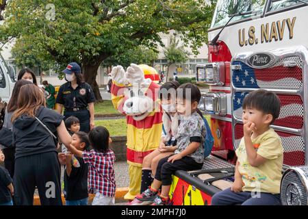 YOKOSUKA, Japan (Okt 16, 2022) – Mitglieder der japanischen Gemeinde fotografieren und posieren mit dem Hund „Sparky“, dem offiziellen Maskottchen der Nationalen Feuerschutzvereinigung an Bord des Kommandanten, Fleet Activities Yokosuka (CFAY) während der jährlichen Feier des Freundschaftstages 44.. Zum ersten Mal seit drei Jahren veranstaltete CFAY eine Open Base Veranstaltung, um die Freundschaft zwischen der lokalen japanischen Gemeinde und der US-Marine hervorzuheben. Seit mehr als 75 Jahren bietet, pflegt und betreibt CFAY Basiseinrichtungen und -Dienste zur Unterstützung der forward-deployed Marineeinheiten der US-Flotte 7., te Stockfoto