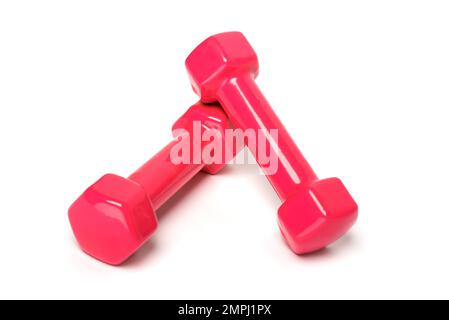 Pinkfarbene oder rote Kurzhanteln isoliert auf weißem Hintergrund. Stockfoto
