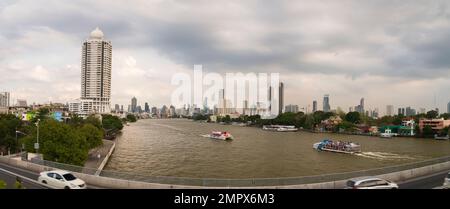 Bangkok, Thailand. 11. Dezember 2022. Blick auf die Stadt vom Chao Phraya Sky Park. Touristenausflugsboote fahren auf dem Chao Phraya Fluss. Stockfoto