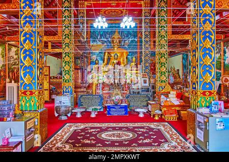 CHIANG MAI, THAILAND - 3. MAI 2019: Im Inneren des Viharn von Wat Dap Phai mit goldenen Bildern von Buddha, blauen und grünen Säulen, bedeckt mit goldenem Flo Stockfoto