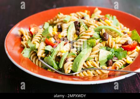Hausgemachter veganer mexikanischer Nudelsalat mit Avocado, Bohnen und Mais. Stockfoto