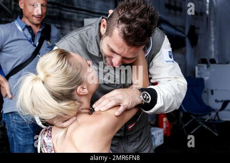 EXKLUSIV!! - Österreichischer Pilot Hannes Arch bekommt einen Glückskuss von seiner Freundin Deutsche Stunt-Frau/Action-Model-Freundin Miriam Holler, die gerade im Rollstuhl sitzt. Das Paar war in seinem Hangar vor dem Masters Cup-Rennen beim Red Bull Air Race 2016 auf der Ascot Rennbahn in Ascot, England. Hannes wurde Dritter im Rennen. 14. August 2016. Stockfoto