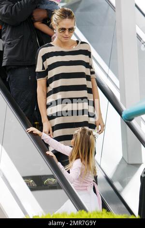 Heidi Klum und ihr Mann Seal fuhren mit ihrer Tochter Leni und ihrer Tochter Lou auf der Rolltreppe, während sie Leni, in ihrem Ballerina-Outfit, zum Tanzkurs brachten. In einem trendigen gestreiften Hemdkleid lächelte Heidi Leni an, während sie liebevoll zu ihrer mutter aufschaute. Los Angeles, Kalifornien. 04/02/11. Stockfoto