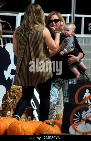 Mike Comrie y su Louis Vuitton Neverfull GM Tote Bag