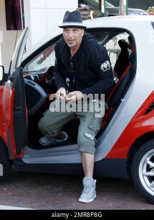 Komiker, Fernsehstar und selbsternannter Germaphobe Howie Mandel steigt aus seinem roten Mini-Smart aus und signiert ein Autogramm, bevor er im Nobu Restaurant speist. Los Angeles, Kalifornien. 07/03/10. Stockfoto