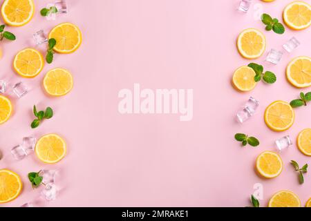 Rahmen aus Zitronenscheiben, Minze und Eis auf pinkfarbenem Hintergrund, Draufsicht mit Platz für Text. Limonade-Layout Stockfoto