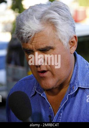 Jay Leno zeigt einem Passanten Fotos von einigen der weltweit bekanntesten Sehenswürdigkeiten, während er den beliebten Abschnitt „Jaywalk“ für „The Tonight Show with Jay Leno“ filmt. West Hollywood, Kalifornien. 8/5/10. . Stockfoto