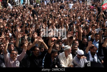 Shiite Muslims chant religious slogans during a Muharram procession, in ...