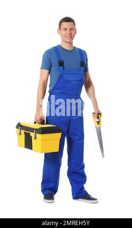 Attraktiver Zimmermann mit Werkzeugkasten und Handsäge isoliert auf Weiß Stockfoto