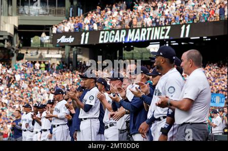 Former Seattle Mariners manager Lou Piniella (14) greets Mariners' Ichiro  Suzuki, right, and former Mariner Edgar Martinez prior to a baseball game  against the Texas Rangers, Saturday, July 16, 2011, in Seattle.