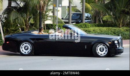 Paris Hilton accessories Scott Storch, Brandon Davis and Kimberly Kardashian live it large in a convertible Bentley, but when it comes to lunch they hit the neighborhood kebab shop beside Paris' swish hotel, 8/15/06 Stock Photo