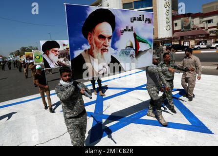 Supporters Of Iraqi Hezbollah Brigades March In Military Uniforms With ...