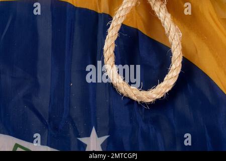 Seil mit einer Schlinge über die brasilianische Flagge, die die Sklaverei im Land symbolisiert Stockfoto