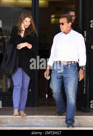 Arnold Schwarzenegger trägt ein Western-Outfit mit Cowboystiefeln aus grünen Krokodilen und geht mit Tochter Christina in Barney's New York in Los Angeles, Kalifornien, einkaufen. 8/8/11. Stockfoto