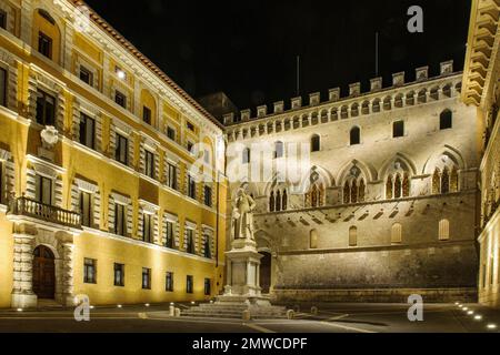 Nachtsicht auf die Piazza Salimbeni mit der Statue von Sallustio Bandini, hinter dem Palazzo Salimbeni mit der ältesten Bank der Welt, Banca Monte dei Paschi, links Stockfoto