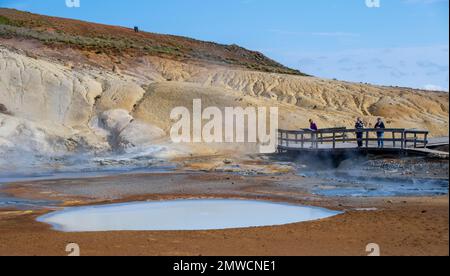 Hölzerne Fußgängerbrücke, Touristen im geothermischen Gebiet Seltun, Mineralvorkommen, Vulkansystem Krysuvik, Island Stockfoto