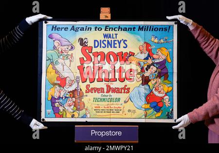Die Mitarbeiter von Propstore passen ein 1944 GB großes Quad-Poster für den Film „Schneewittchen und die sieben Zwerge“ aus dem Jahr 1937 (geschätzt 2000 - 4000 £) während einer Vorschau für die Auktion der Erinnerungsstücke des Showbiz im Propstore in Rickmansworth, Hertfordshire, an. Foto: Donnerstag, 19. Januar 2023. Stockfoto