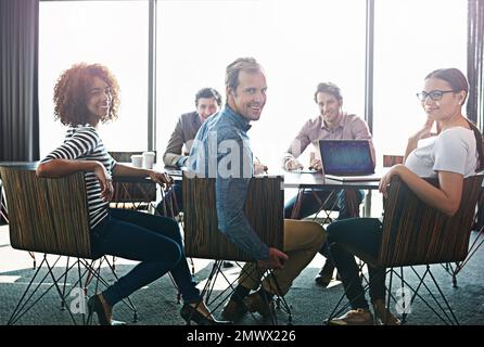 Gleichgesinnte Profis. Porträt einer Gruppe von Bürokollegen, die an einem Konferenztisch sitzen. Stockfoto