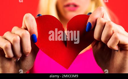 Gebrochenes Herz. Scheidung. Schluss Machen. Eine Frau, die Papierherz zerreißt. Konzept. Bruch von Beziehungen. Nahaufnahme. Stockfoto