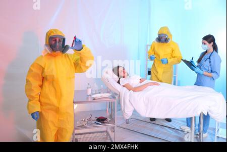 Professionelle Sanitäter untersuchen Patienten mit Virus in der Quarantänestation Stockfoto