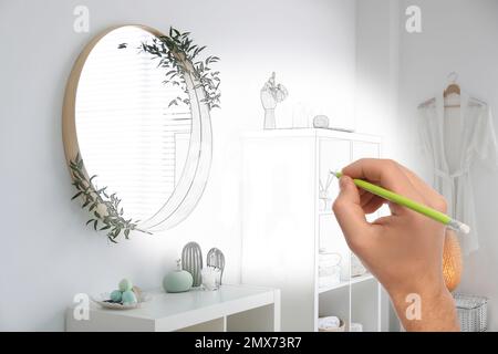 Mann zeichnet Innenausstattung im Badezimmer. Kombination aus Foto und Skizze Stockfoto