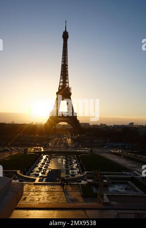 Eiffelturm und Brunnen in der Nähe bei Sonnenaufgang in Paris. Stockfoto