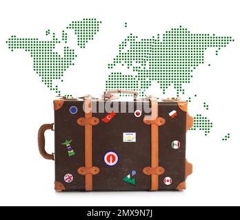 Retro-Koffer mit Reiseaufklebern und Weltkarte auf weißem Hintergrund Stockfoto