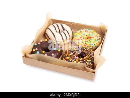 Schmackhafte glasierte Donuts in einer Pappschachtel isoliert auf weiß Stockfoto