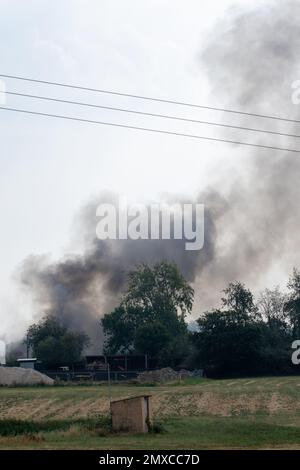 Rauch steigt von einem schweren Brand auf einem kleinen Industriegebiet in Suffolk Ackerland Stockfoto