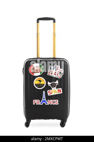 Moderner Koffer mit Reiseaufklebern auf weißem Hintergrund Stockfoto