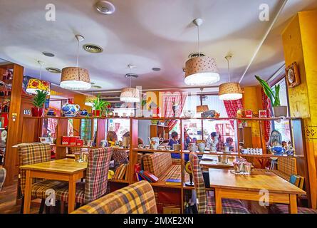 KIEW, UKRAINE - 23. MAI 2021: Inneneinrichtung des Restaurants im Stil einer sowjetischen Wohnung mit Holzmöbeln, altem Porzellan-Geschirr auf den Regalen, pl Stockfoto
