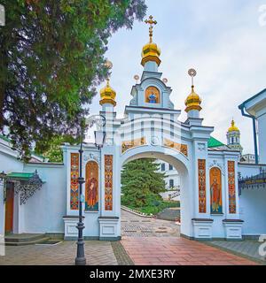 Das reich verzierte, mit Fresken verzierte Tor mit goldenen Zwiebelkuppeln, das Gelände der nahe gelegenen Höhlen (Höhlen der Heiligen Gemütsruhe) von Kiew Pechersk Lavra Cave Mon Stockfoto