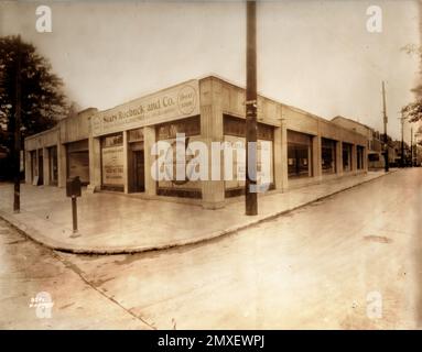 1930er Jahre Vintage Foto von Sears Roebuck und Co. Storefront: Historische Art déco-Architektur eines ikonischen Einzelhandelsstandorts mit „Opening Soon“-Schildern, die Allstate-Reifen und Auto-Zubehör anzeigen – seltenes Originalbild der amerikanischen Einzelhandelsgeschichte Stockfoto