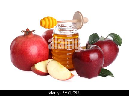 Honig, Äpfel und Granatäpfel auf weißem Hintergrund. Jüdischer Neujahrsfeiertag (Rosh Hashanah) Stockfoto