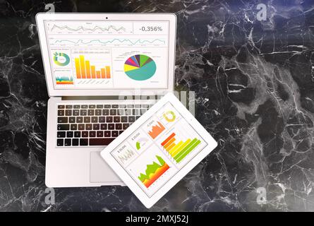 Moderne Geräte auf Marmortisch, Draufsicht. Geschäftsanalysen Stockfoto