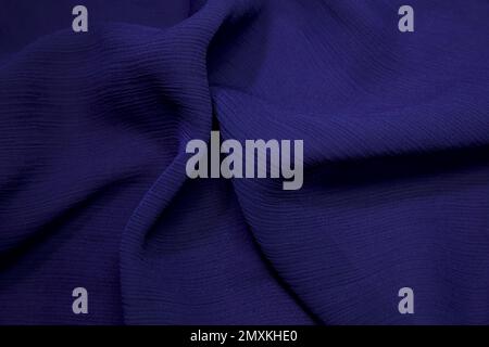 Blauer Stoffhintergrund. Blaues Tuch Wellen Hintergrundstruktur. Blaues Stoffgewebe Textilmaterial. Stockfoto