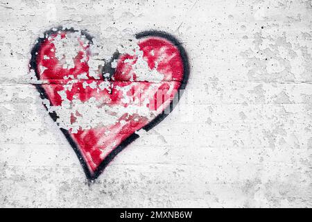 Großes schwarzes und rotes Herz, mit Sprühfarbe an der Wand gemalt, ein Symbol der Liebe. Valentinstag. Stockfoto
