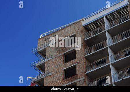 Mehrstöckiges Wohngebäude im Bau, ein Bruchteil des Hauses. Keramikziegelwände, monolithische Betonplatten Stockfoto