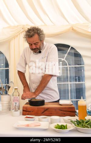 BILDER ABLEGEN. 4. Februar 2023. Nach der Covid-19-Pandemie ließ Mark Hix eine Terrassenfläche im Freien vor seinem Oyster and Fish House in Lyme Regis, Dorset, bauen. Die Ratsmitglieder des Stadtrats von Lyme Regis haben Hix mitgeteilt, dass sein „illegaler“ Terrassenbereich im Freien nun bis Ende März 2023 stillgelegt werden muss. Mehr als 4000 Menschen haben einen Wunsch unterschrieben, dass es bleibt. Sein Restaurant überblickt den berühmten Cobb in Lyme Bay, der Schauplatz des französischen Lieutentant-Frauenfilms mit Meryl Streep und Jeremy Irons war. Tetbury, Großbritannien. 1. Juni 2022. Kochvorführung des berühmten Küchenchefs Mark Hix Stockfoto