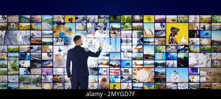 Konzept der Medienbibliothek. Mann mit virtueller Videogalerie, Bannerdesign Stockfoto