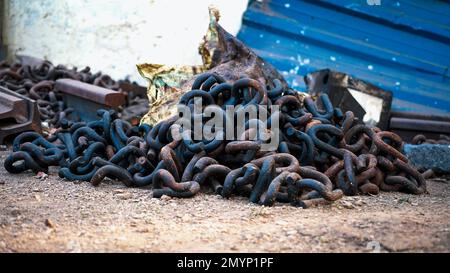 Nahaufnahme von rostigen Metallketten, Bilder von rostigen Ketten, Ketten aus der Vergangenheit, braune Metallketten mit Rost und Boden, Texturen aus Metallmatte Stockfoto