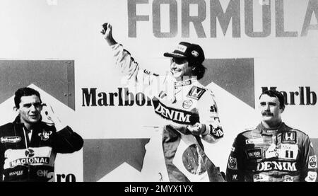 Nelson Piquet, center, of Brazil waves from the podium after winning the Hungarian Formula 1 Grand Prix driving a Williams-Honda, at the Hungaroring racing circuit in Mogyorod, Hungary on Aug. 10, 1986. Ayrton Senna, left, of Brazil came in second driving a Lotus-Renault and Nigel Mansell, right, Piquet's teammate, finished third. (AP Photo/Armando Trovati)