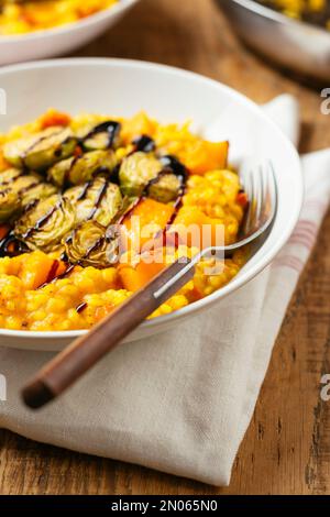 Squash Risotto mit geröstetem Rosenkohl und Balsamico-Reduktionsmittel Stockfoto